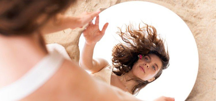 Come ritrovare se stessi-ritratto di giovane donna riflessa in uno specchio tondo Come ritrovare se stessi-ritratto di giovane donna riflessa in uno specchio tondo