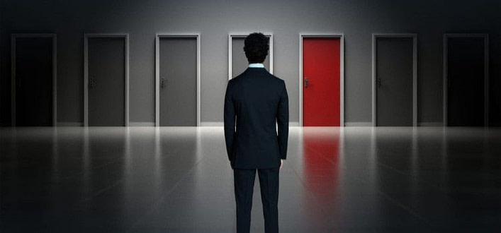 Frasi sulle scelte da fare-uomo di spalle di fronte a tante porte Frasi sulle scelte da fare-uomo di spalle di fronte a tante porte
