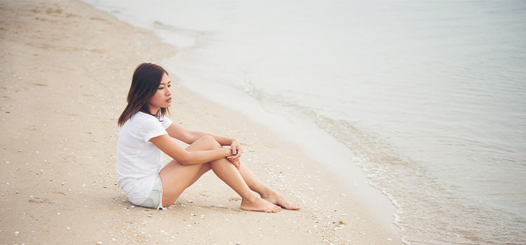 sentirsi-soli-ragazza-seduta-in-riva-al-mare