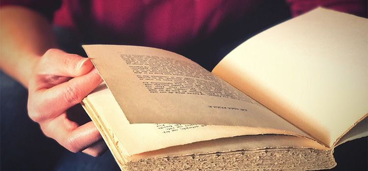 ansia a chi rivolgersi - un libro ingiallito tenuto in mano da una donna