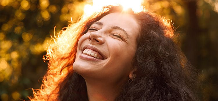 La felicità esiste - primo piando di una ragazza sorridente con gli occhi chiusi